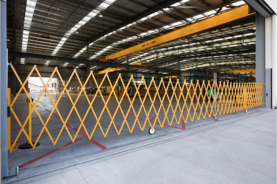 A wall-mounted safety barrier at the entrance of a workshop